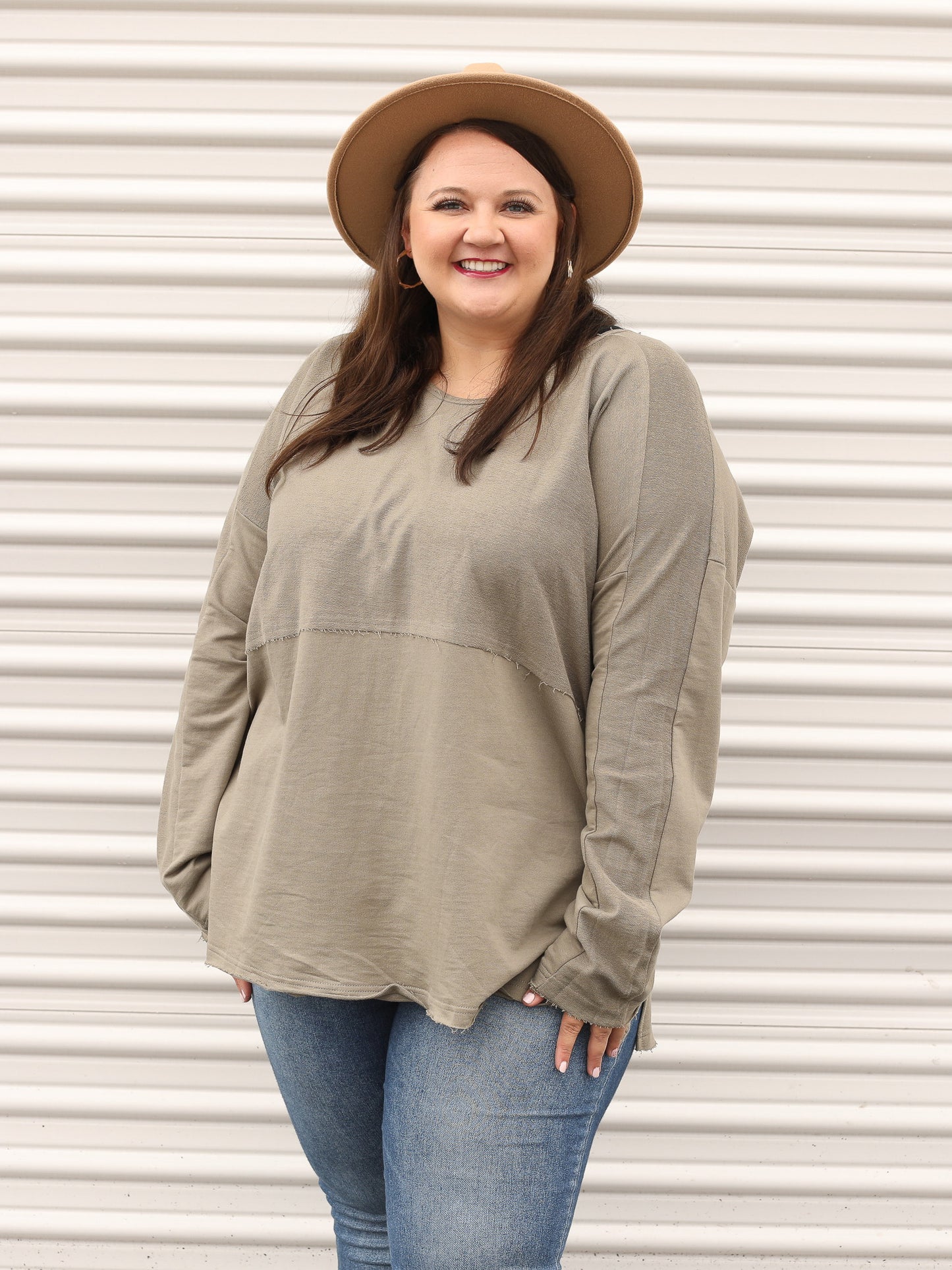 Green long sleeve dressed up with a hat and denim