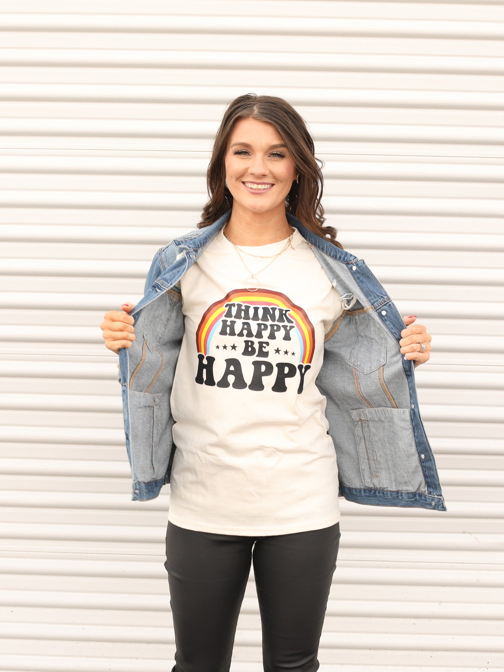 Graphic tee with "Think happy by happy" and a rainbow