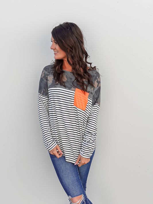 Mix print top. Striped top with camo print on the neckline and shoulders and a bright pink neon pocket.