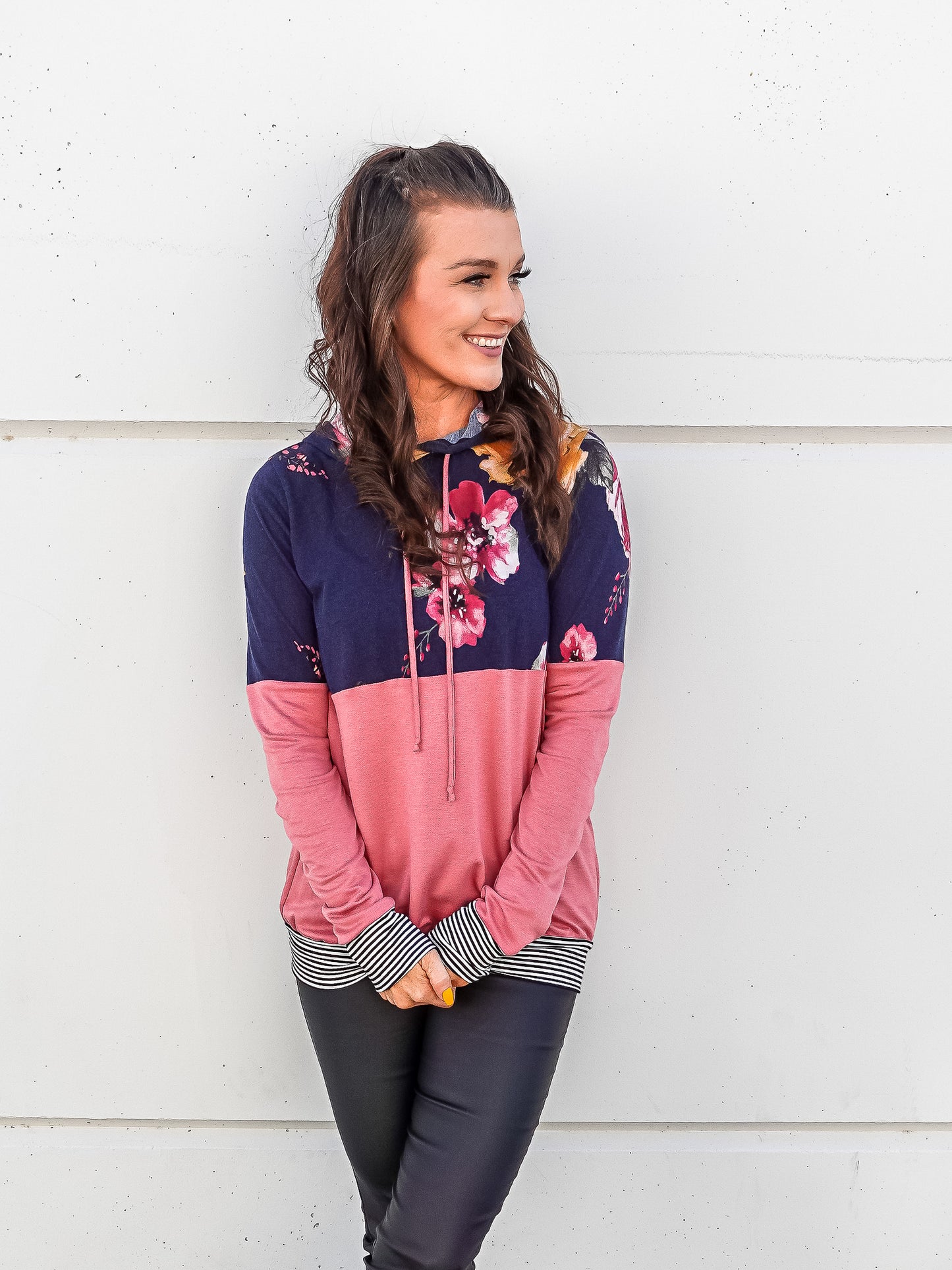 Color blocked light weight hoodie with pink on the bottom and navy and floral top. 