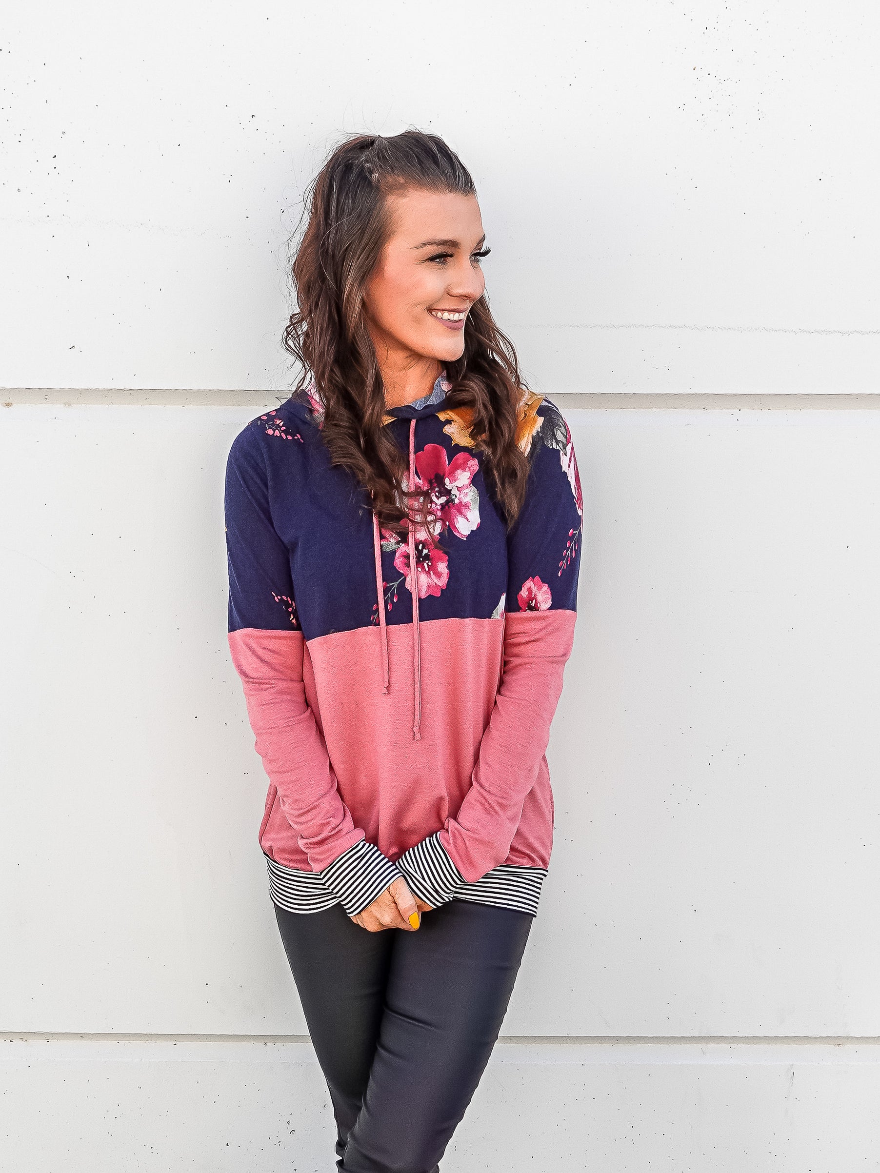 Color blocked light weight hoodie with pink on the bottom and navy and floral top. 