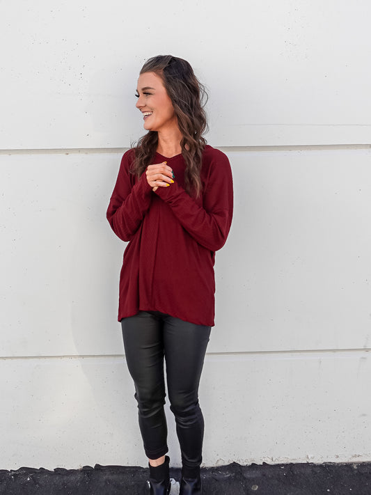 Maroon red colored long sleeve and n neck. 