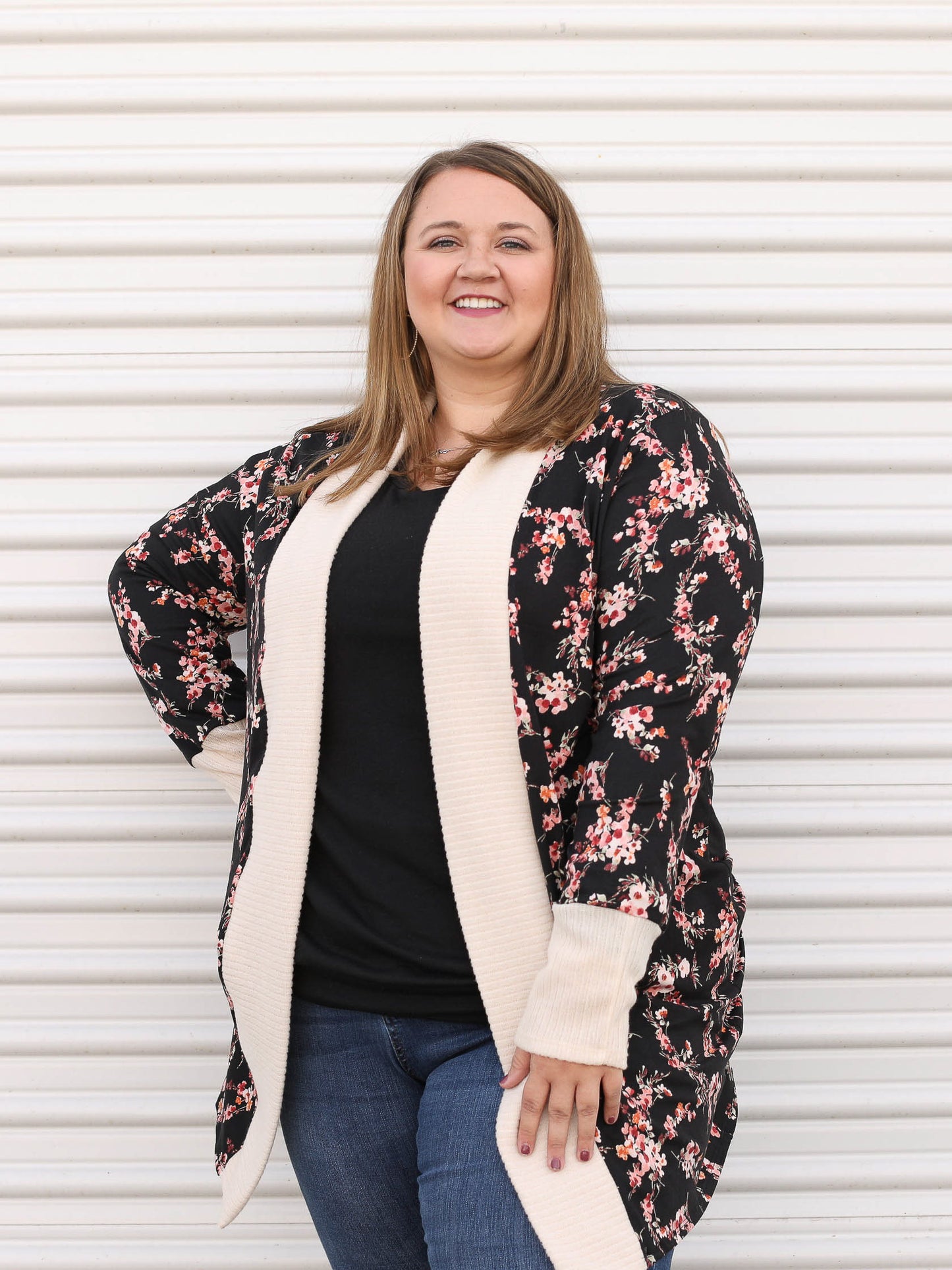 Floral cardigan with ivory trim and pink floral details.