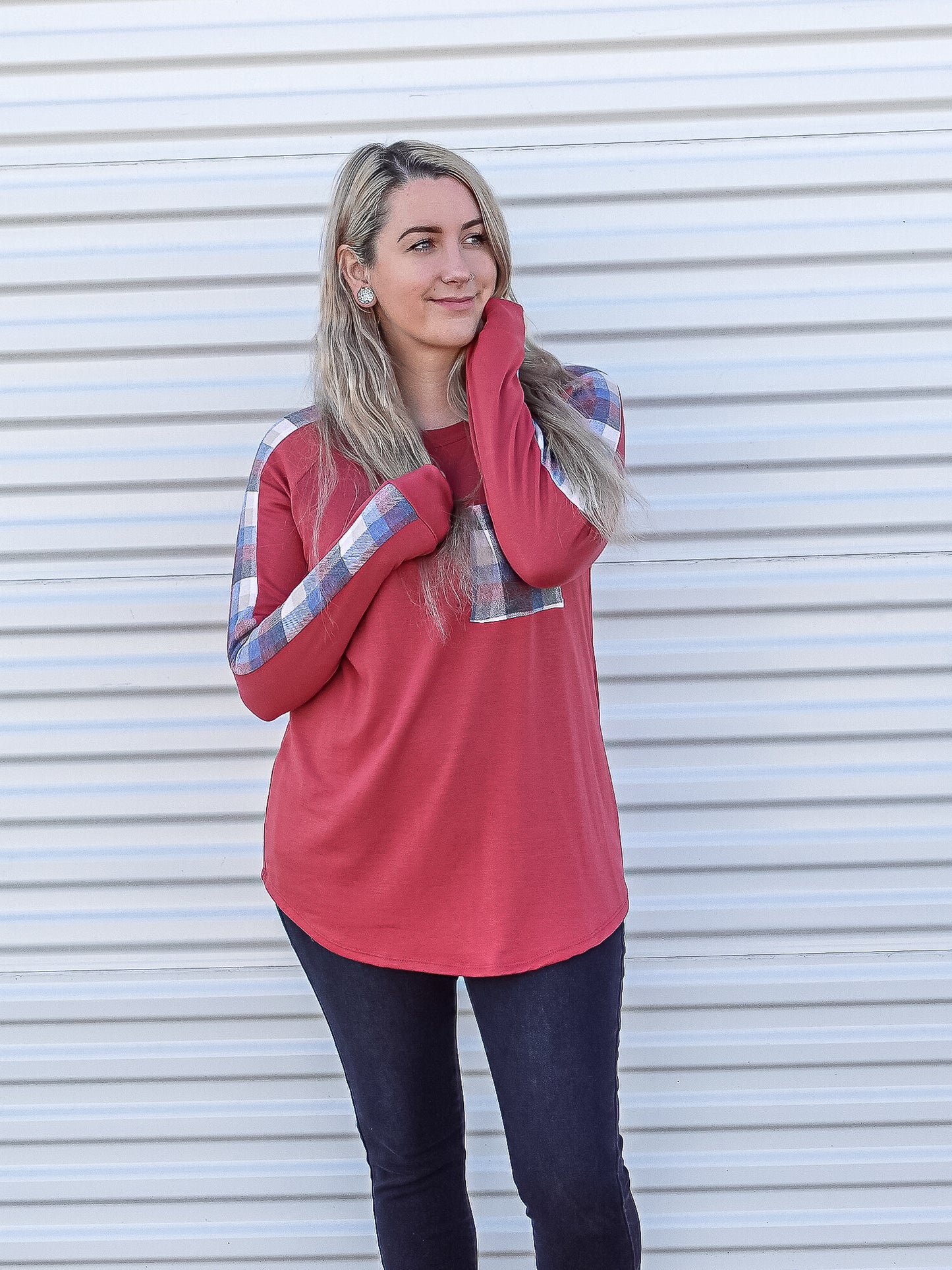 Cranberry red long sleeve with blue plaid detail on the pocket and down the top of the sleeves.