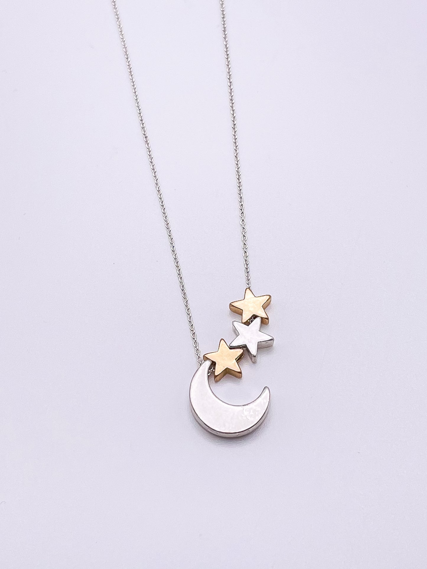 Silver necklace with moon and starts.