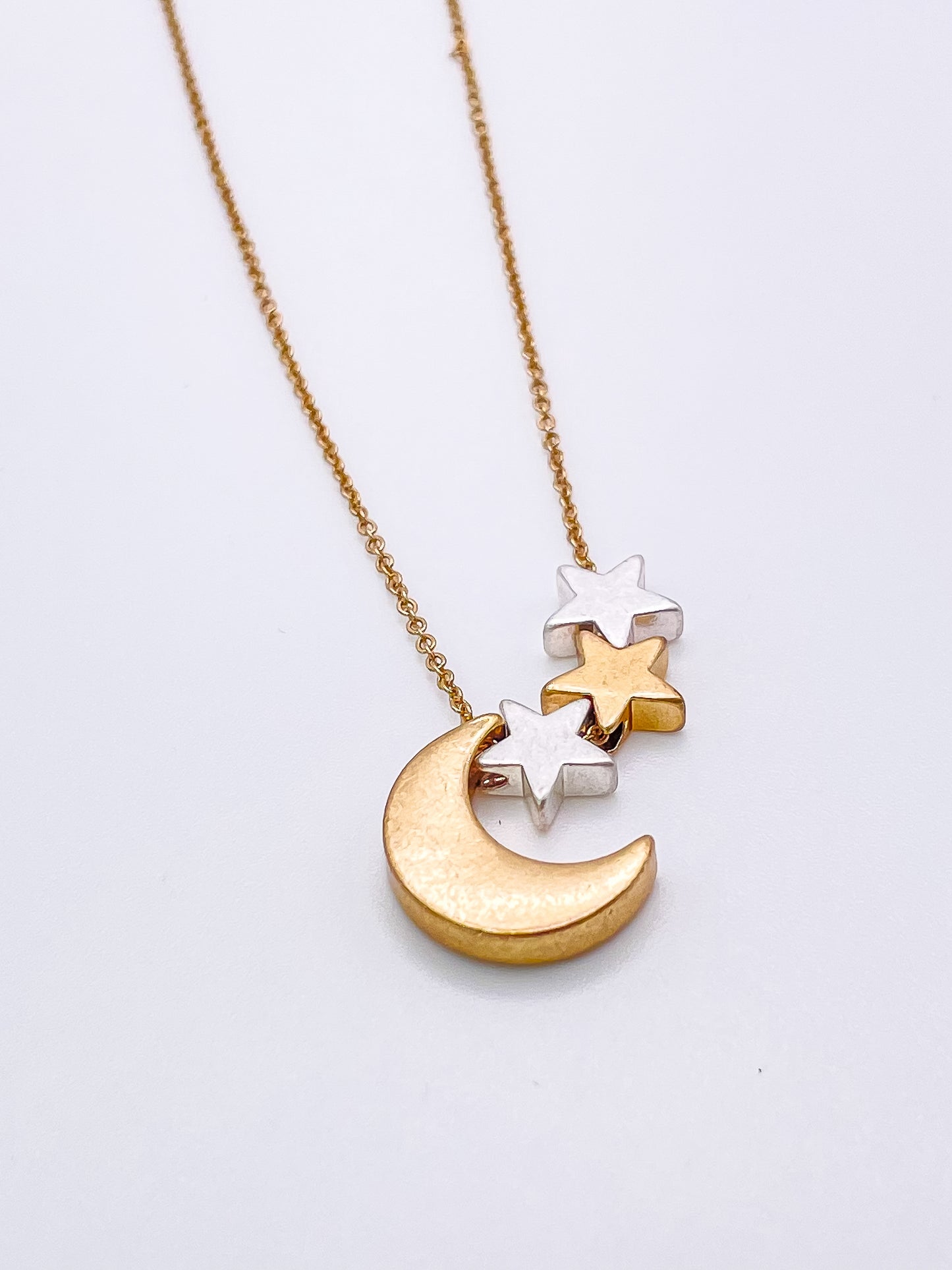 Gold necklace with moon and stars.