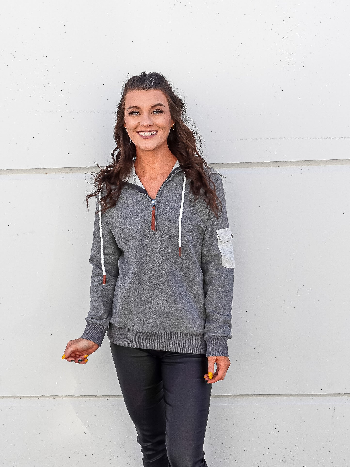 Front view, dark grey pull over with elbow patch and rope style drawstrings.