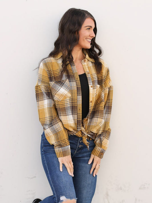 Gold plaid button up tied at the waist styled with denim.