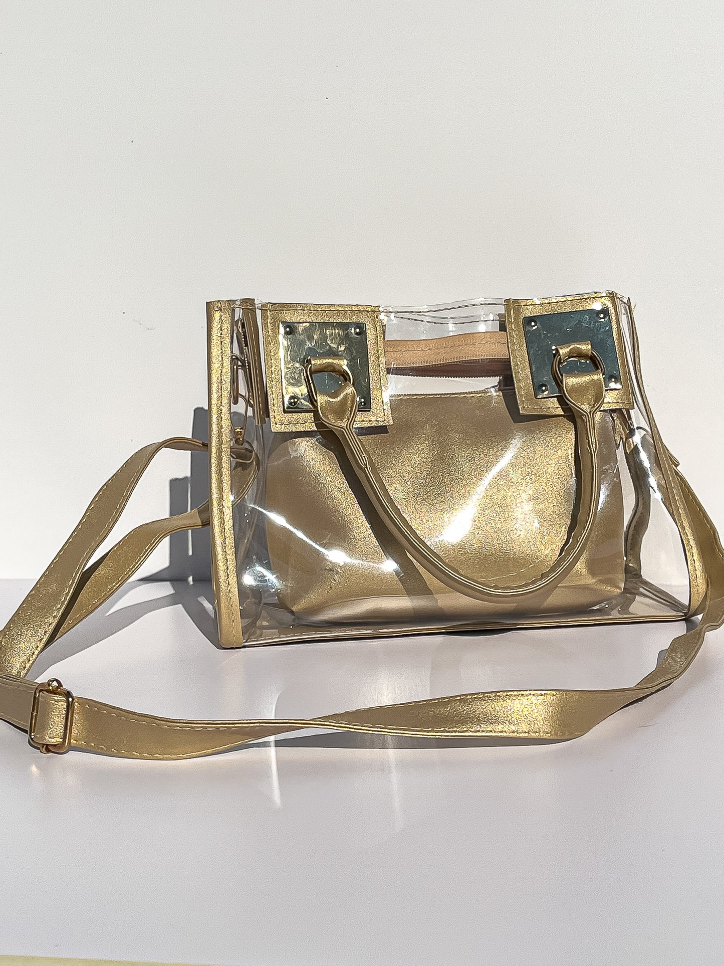 Clear Crossbody purse with gold accents and straps