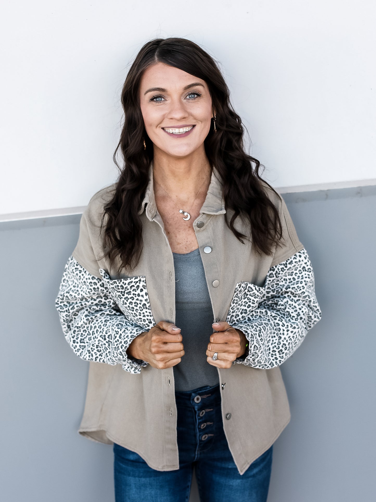 Tan jacket with functional buttons and leopard sleeves and pockets. 