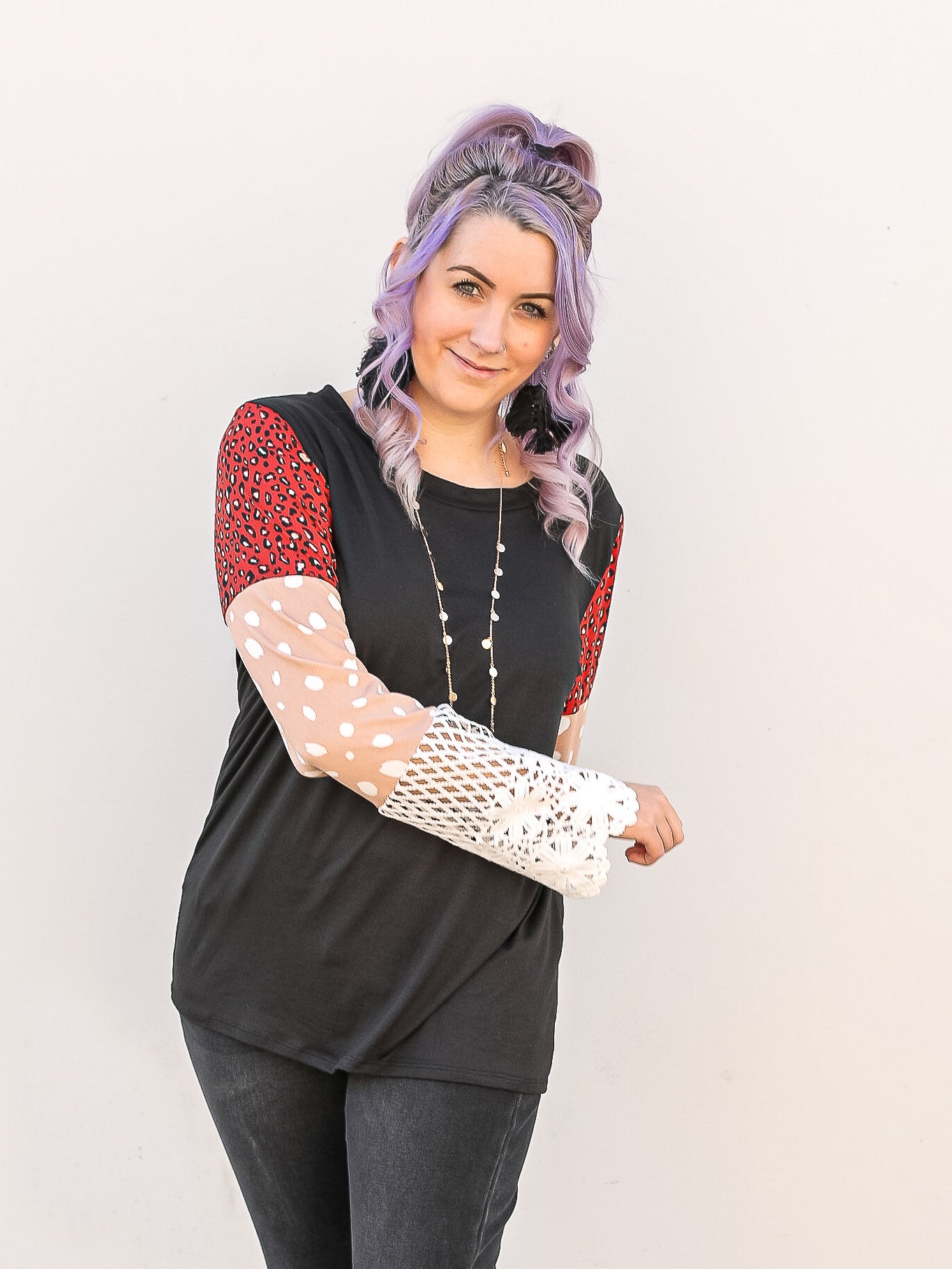 Black long sleeve with colored blocked sleeves in leopard, pok a dot and knit details.