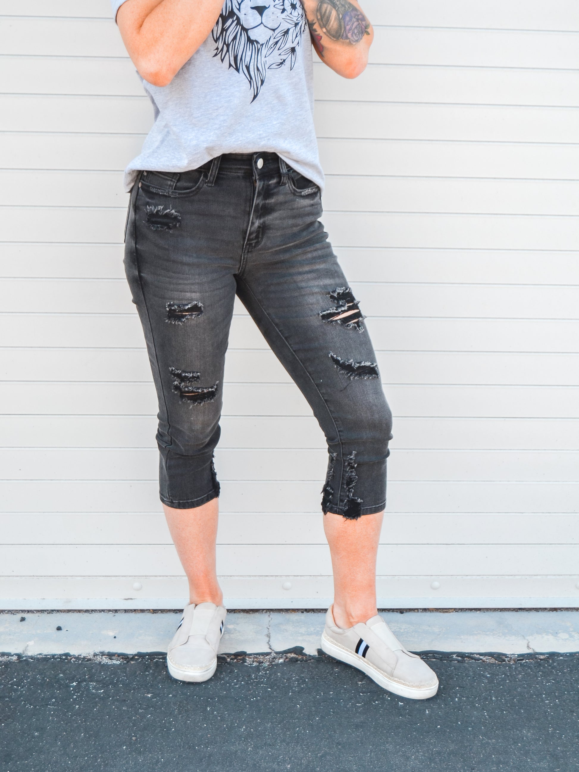 Black capris with distressing down the front.