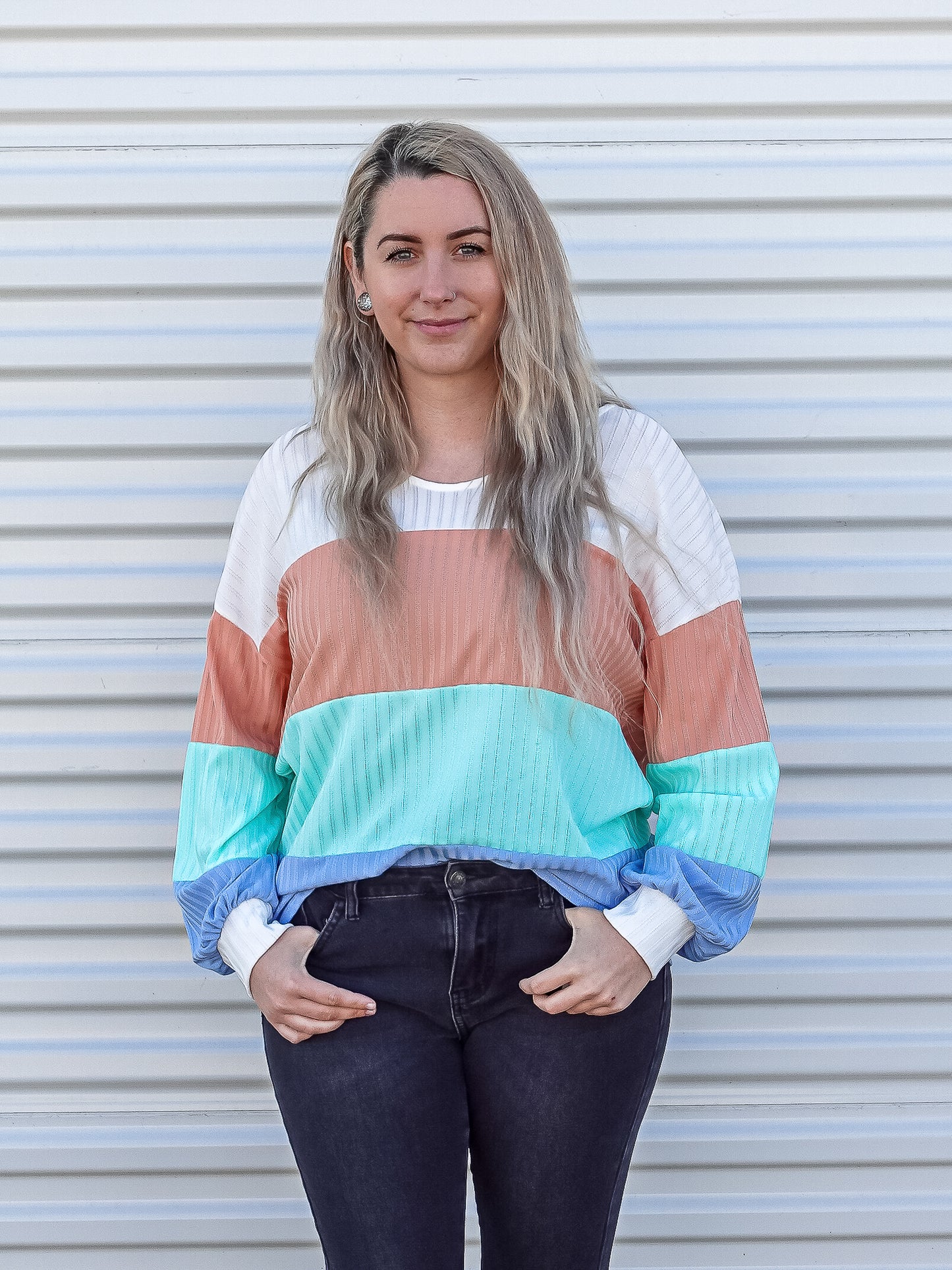Colored blocked long sleeve top with rounded v-neck.