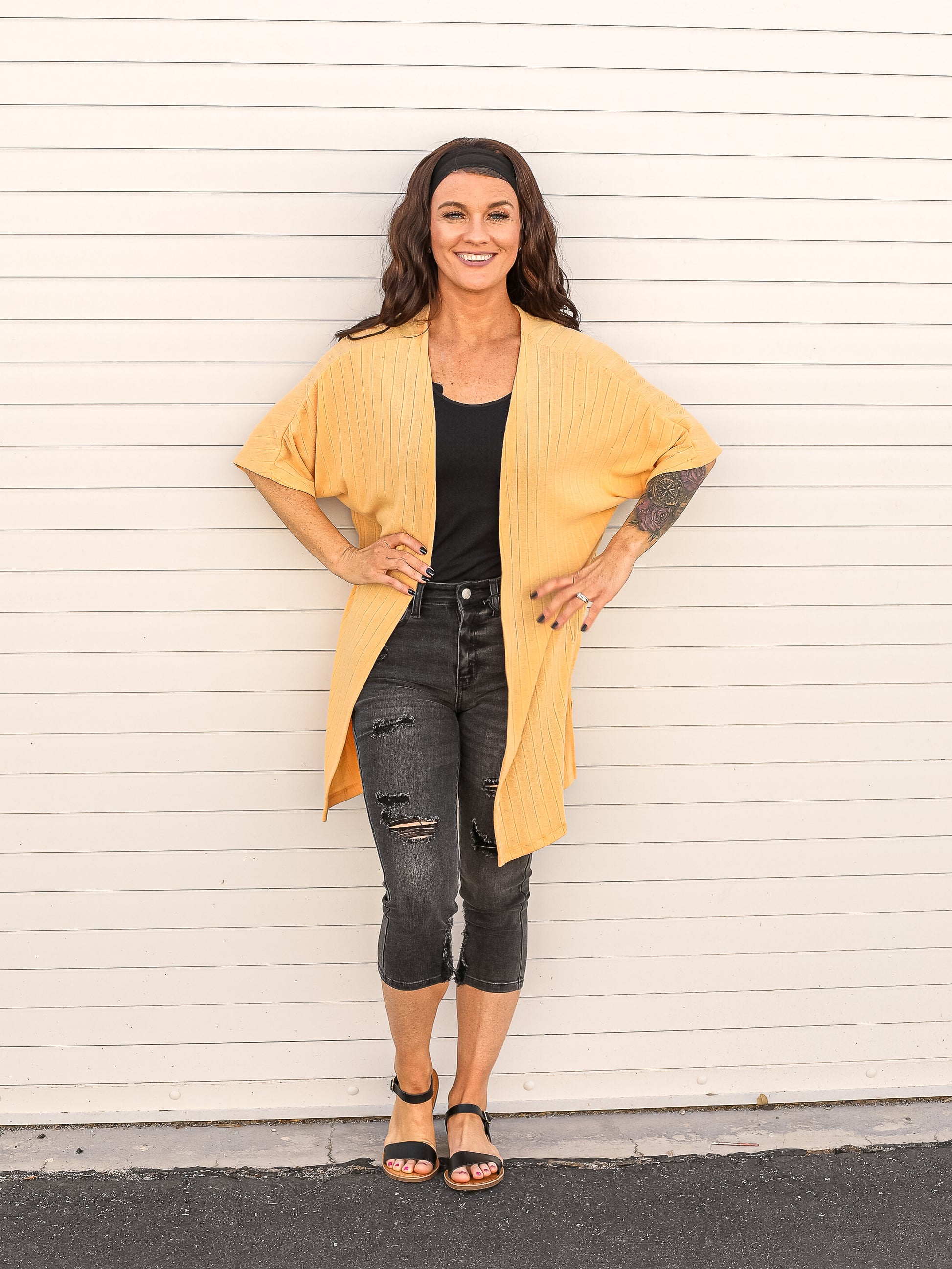 Butternut colored ribbed long open cardigan. Styled with capris and a tank top.