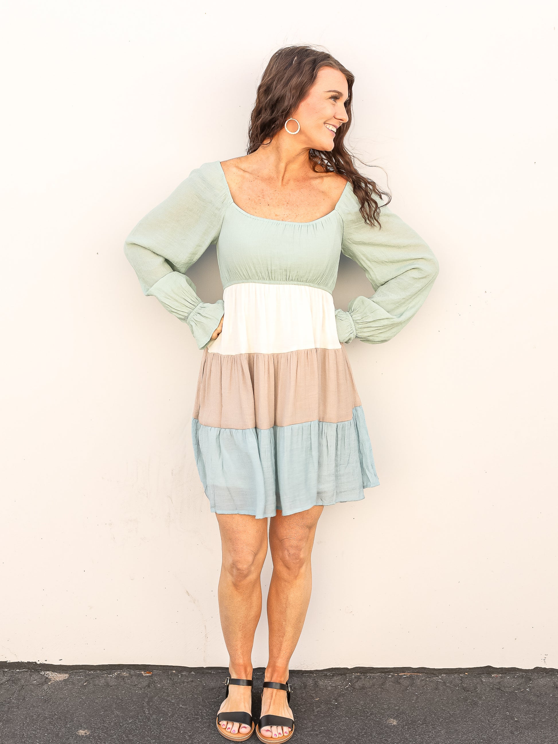 Beautiful spring dress with pastel colored blocked down the tiers of the dress. Styled with sandals. 