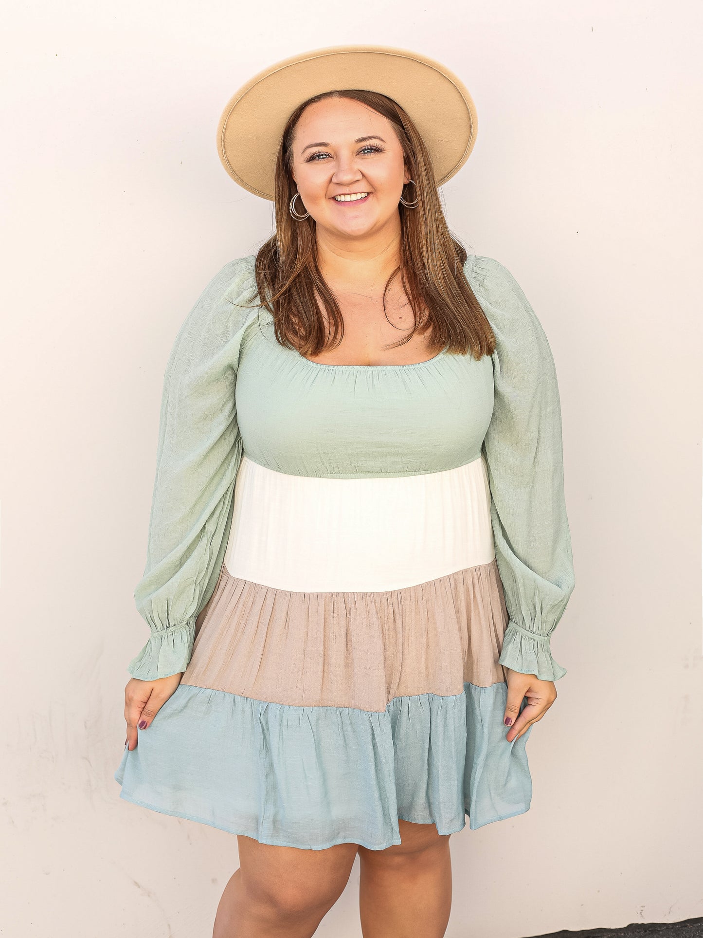 Colored block, mint, white, taupe and blue tired dress with balloon mint colored sleeves.