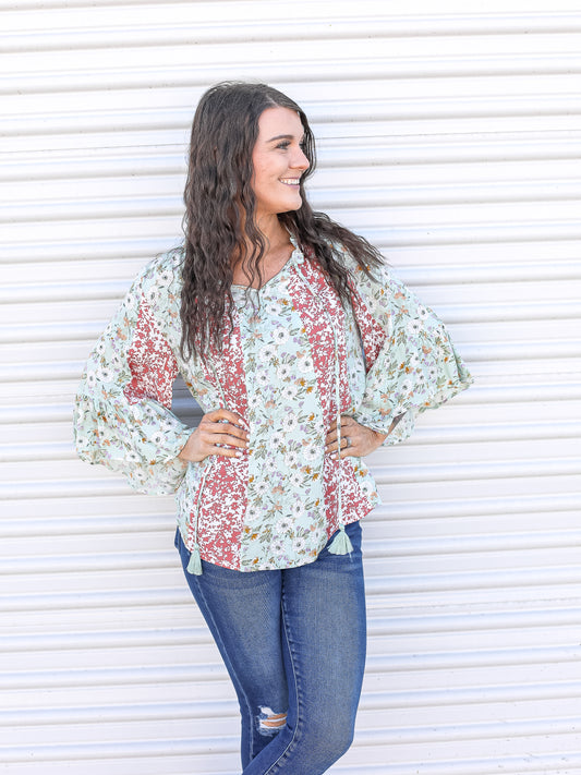 Mixed floral print blouse with green and red floral color block details,