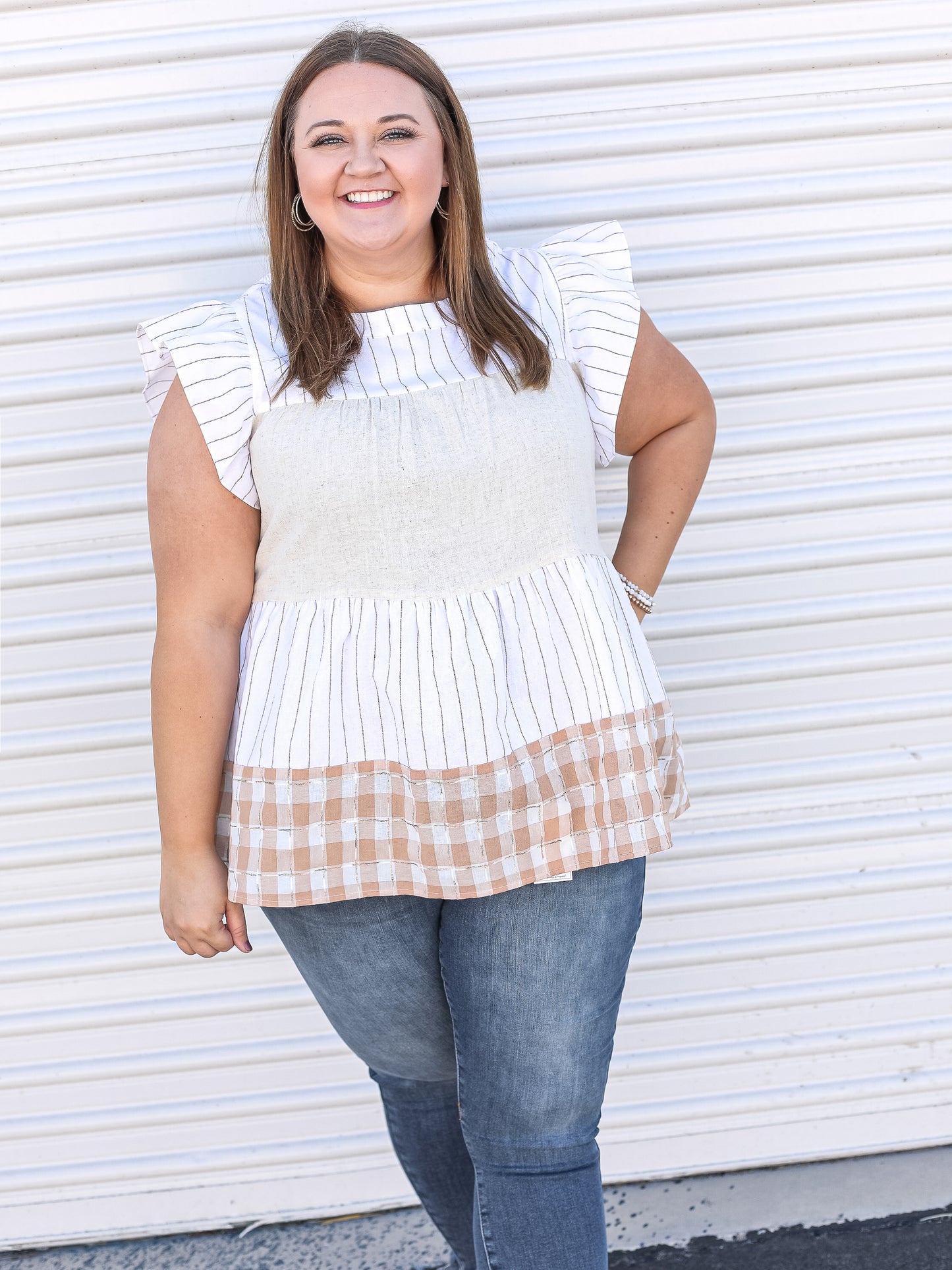 Color blocked tiered blouse, with white, stripes and checkered details.