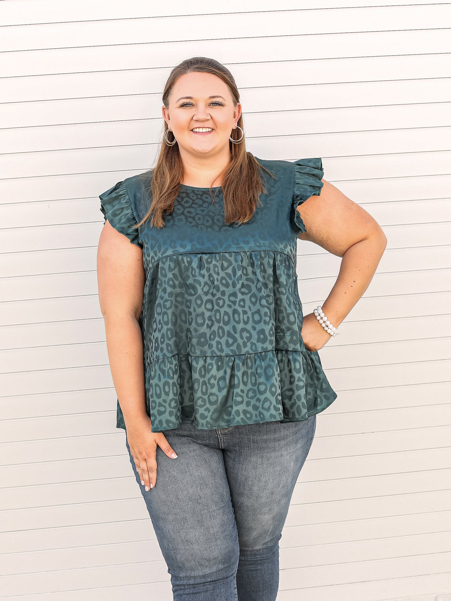 Emerald green sleeveless blouse with light leopard details