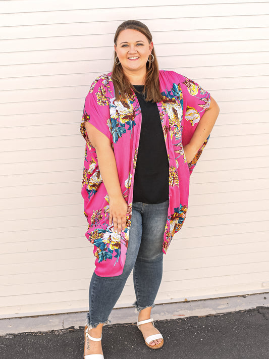 Neon pink kimono with bright floral colors details.