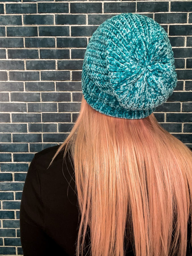 Back view of teal beanie. 